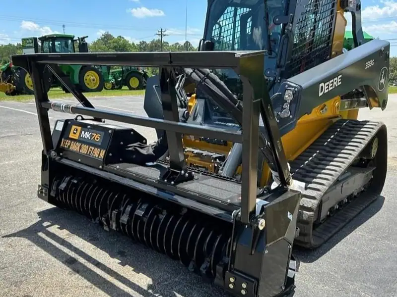 A John Deere tracked loader with a forestry mulching head